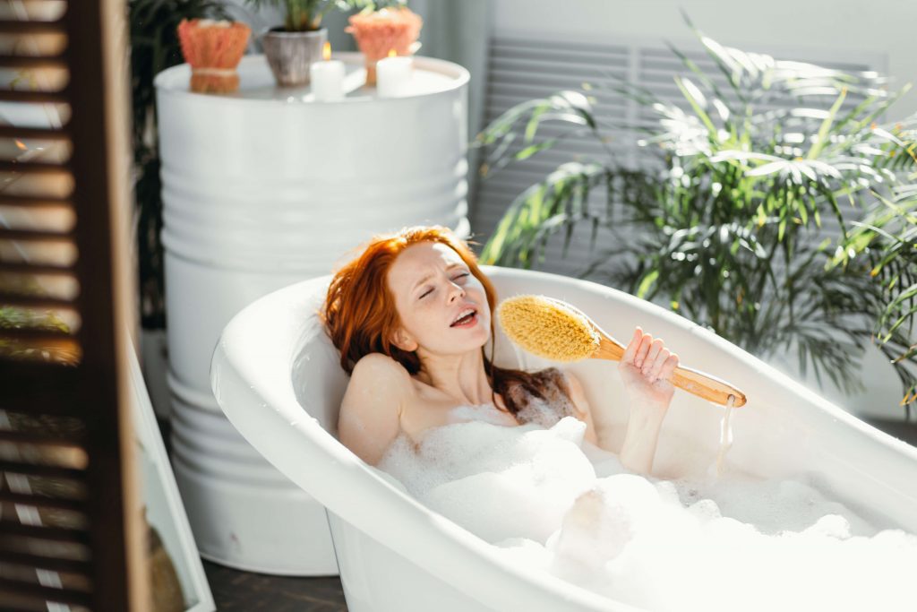 female in soaking bubble bathtub